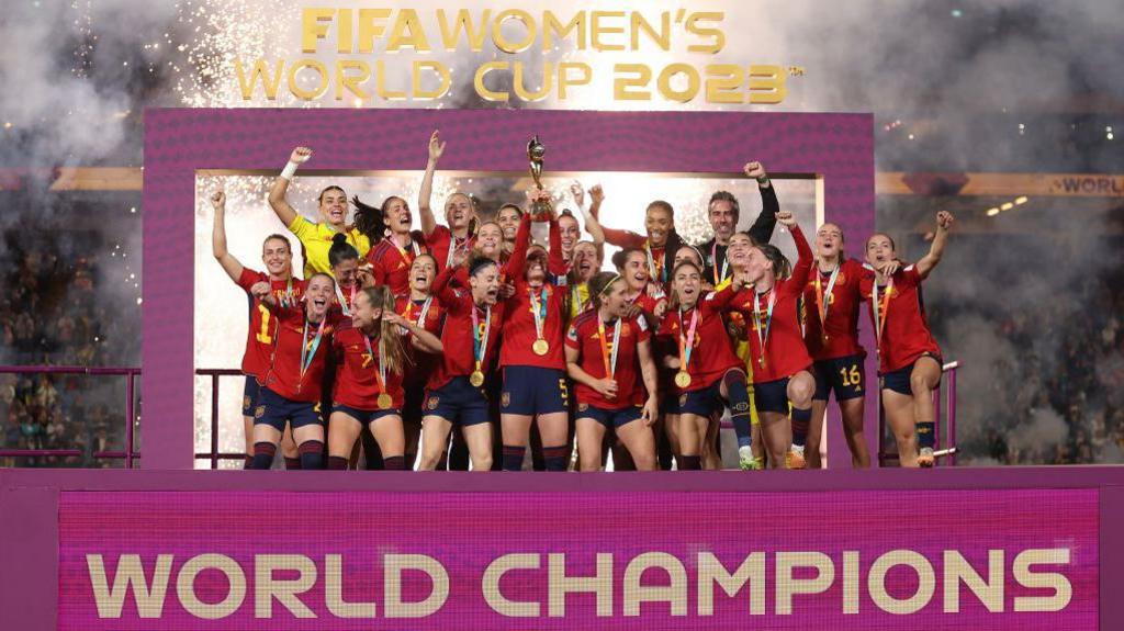 Spain's players and officials celebrate with the trophy after winning the Australia and New Zealand 2023 Women's World Cup final football match between Spain and England at Stadium Australia in Sydney on August 20, 2023. 