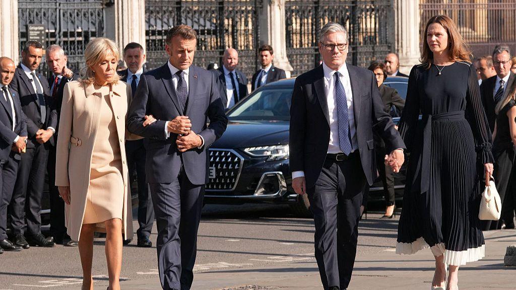 Britain's Prime Minister Keir Starmer (2R) and his wife Victoria Starmer (R), alongside France's President Emmanuel Macron (2L) and his wife Brigitte Macron (L) arrive to attend a ceremony at the statue of war-time Prime Minister Winston Churchill, in Parliament Square,