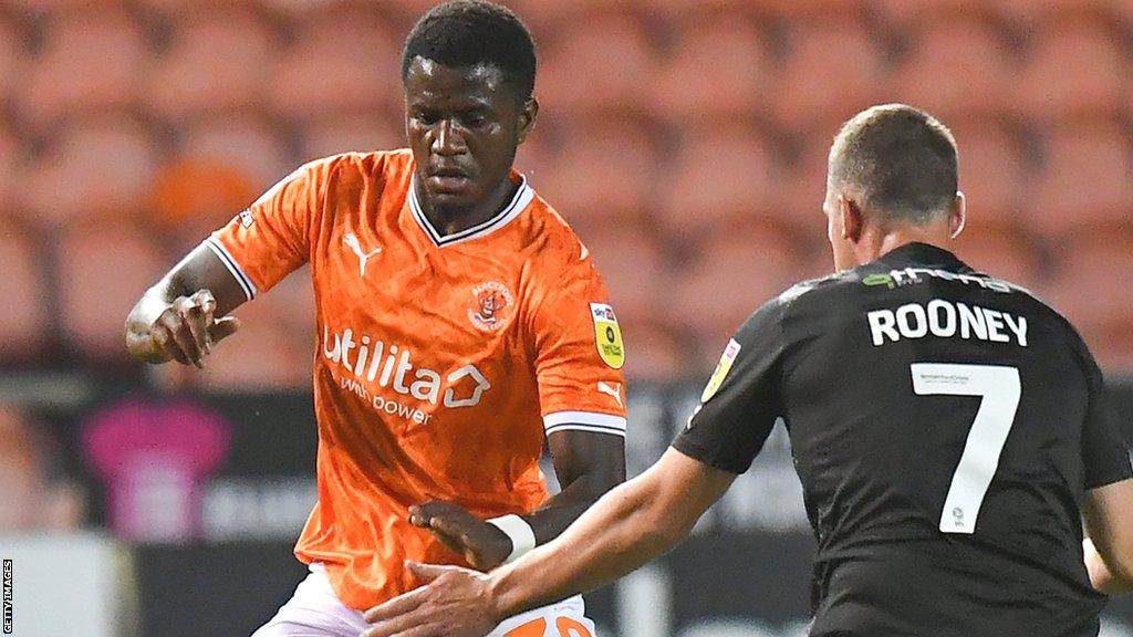 Blackpool's Beryly Lubala (left) battles with Barrow's John Rooney during the Carabao Cup first round match between Blackpool and Barrow at Bloomfield Road in August 2022