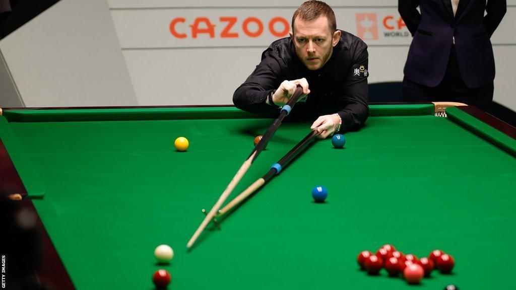 Mark Allen plays a rest shot against Jak Jones