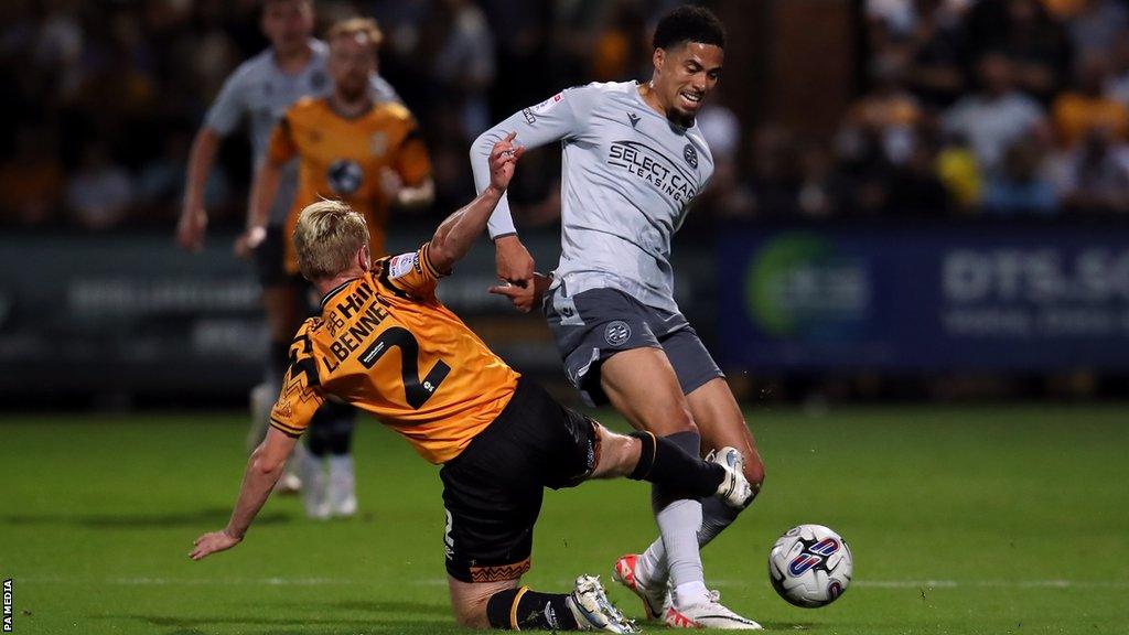 Cambridge defender Liam Bennett battles with Reading player Harvey Knibbs