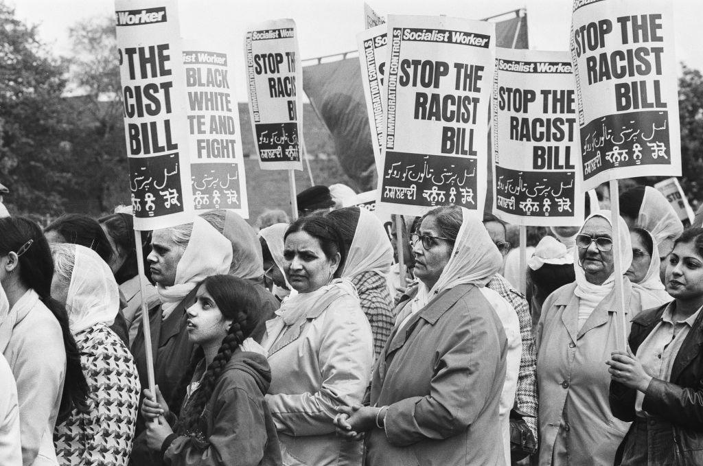 Asian women taking part in a peace march in Coventry following the fatal stabbings of Satnam Singh Gill and Dr Amal Dharry. Some are carrying placards reading Stop the Racist Bill