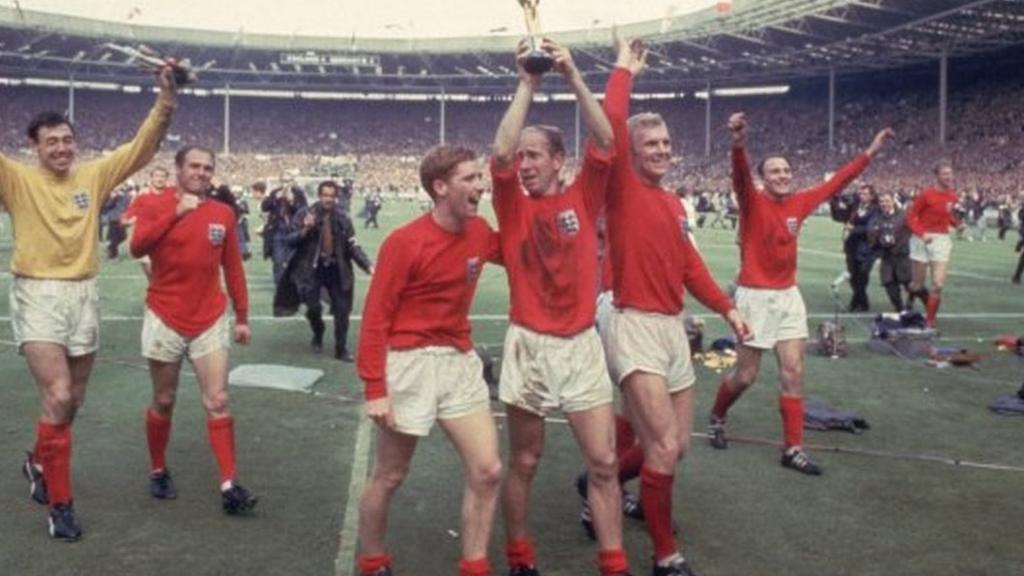 Bobby Charlton holds the World Cup trophy at Wembley after helping England win the final in 1966