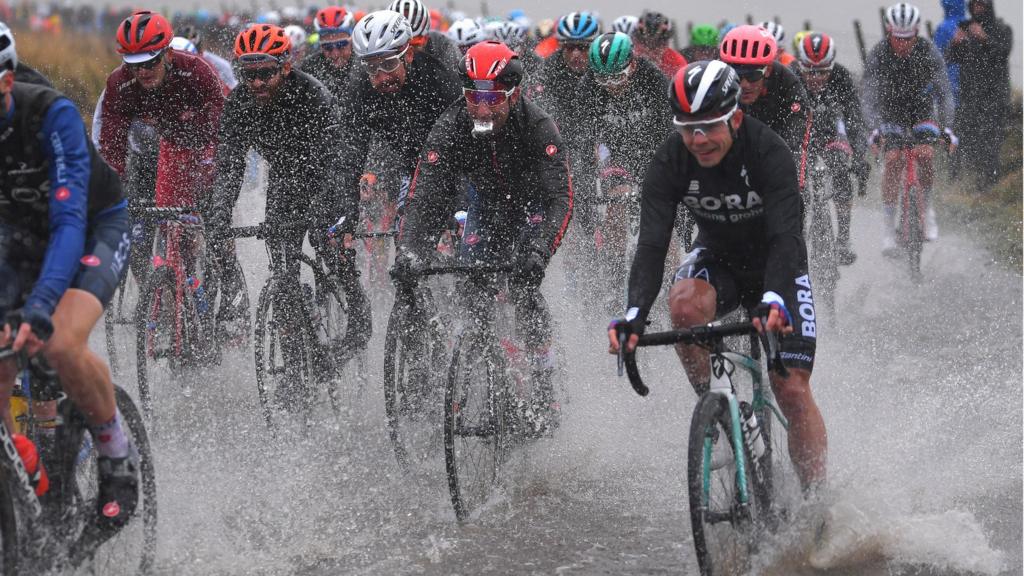 Cyclists riding through the rain