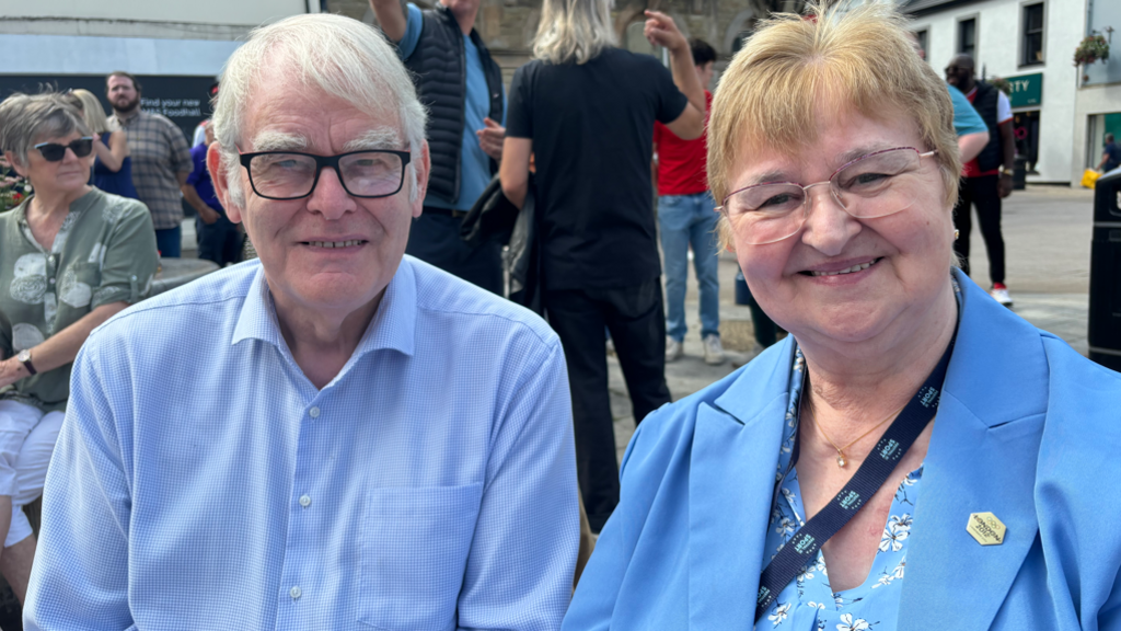 Man and woman smiling into camera