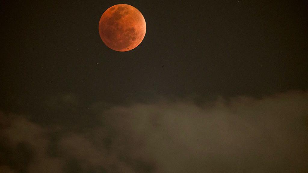 The Blood Moon above the clouds in Johannesburg, South Africa