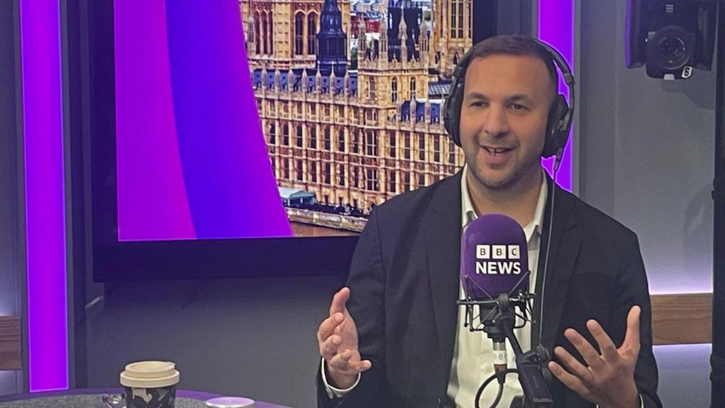 Zack Polanski is sitting in a studio behind a mic saying "BBC News" 