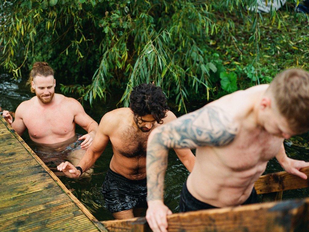 Anthony Mullaly and two other camp-mates climb out of the open water