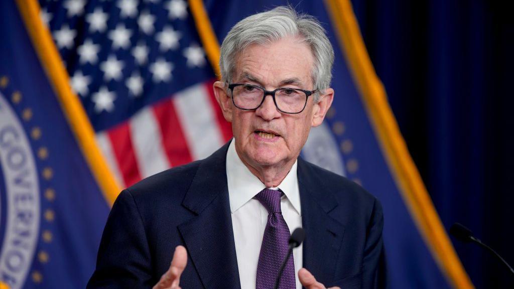 Federal Reserve chairman Jerome Powell at a podium at a press conference to discuss the bank's rate cut