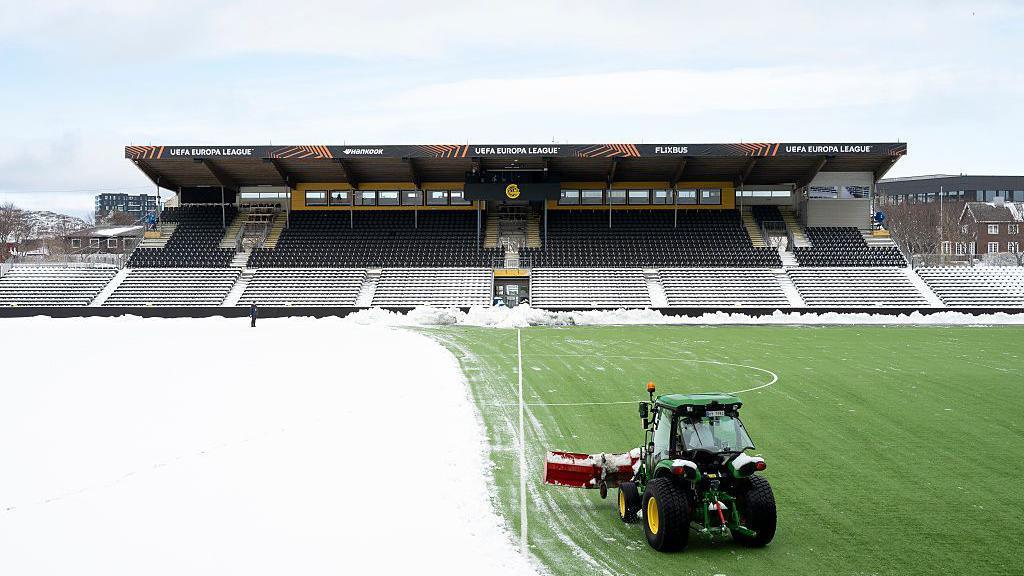 Snow being shovelled off the pitch at Bodo/Glimt