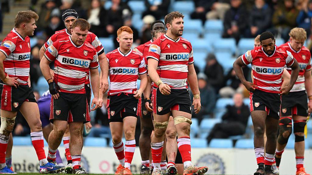 Gloucester players walk across the pitch after conceding a try during the Prem Rugby Cup defeat to Exeter in February