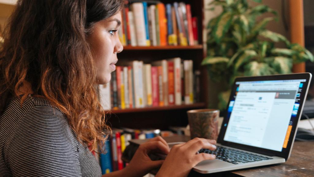 A woman taping at a computer