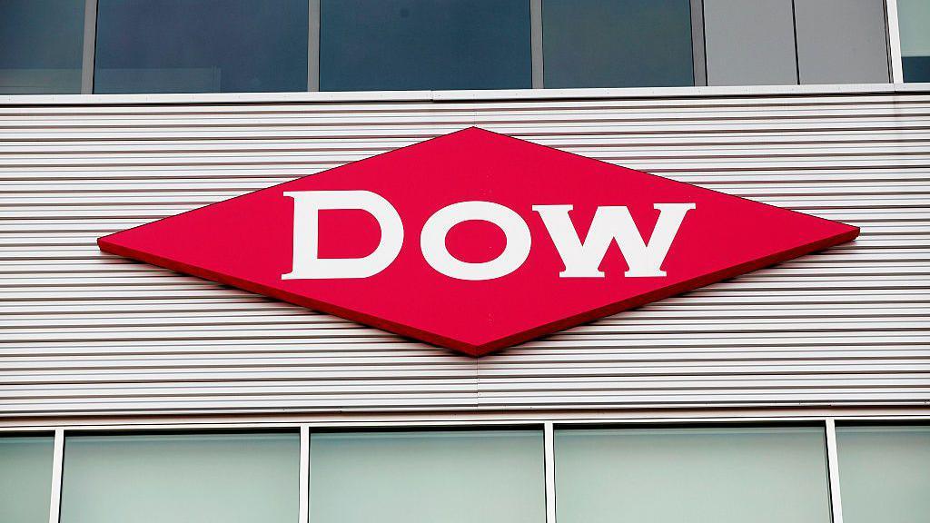 The red diamond logo of Dow chemicals on the side of an unknown building.
