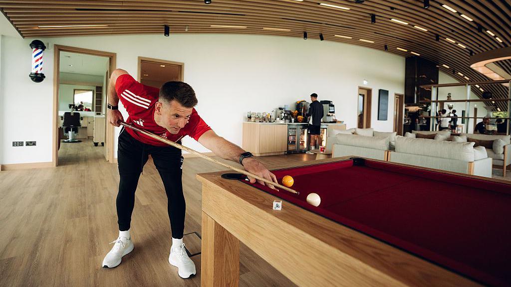 player Tom Heaton explores the new games and barber facilities.