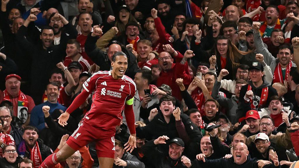 Virgil van Dijk celebrates in front of The Kop