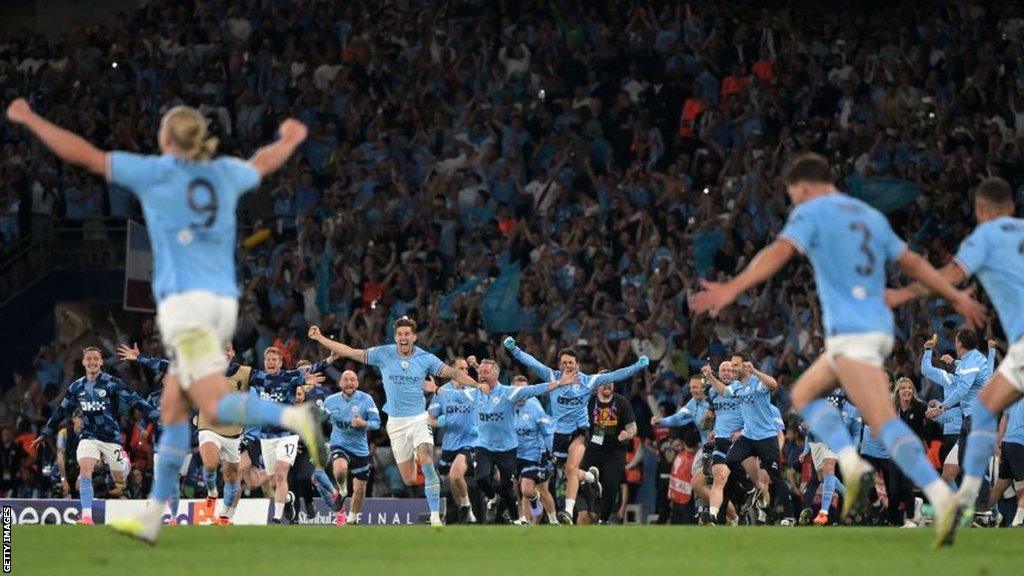 Manchester City players and staff celebrate winning the Champions League