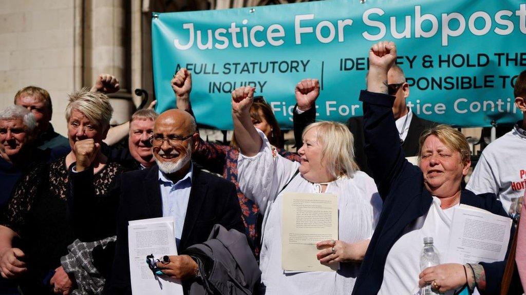 Former subpostmasters celebrate outside the Royal Courts of Justice in London