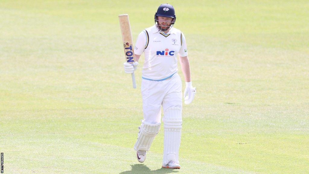 Jonny Bairstow raises his bat after reaching 50