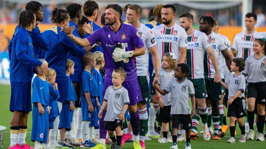 Wrexham and Chelsea players line up for a friendly in 2023