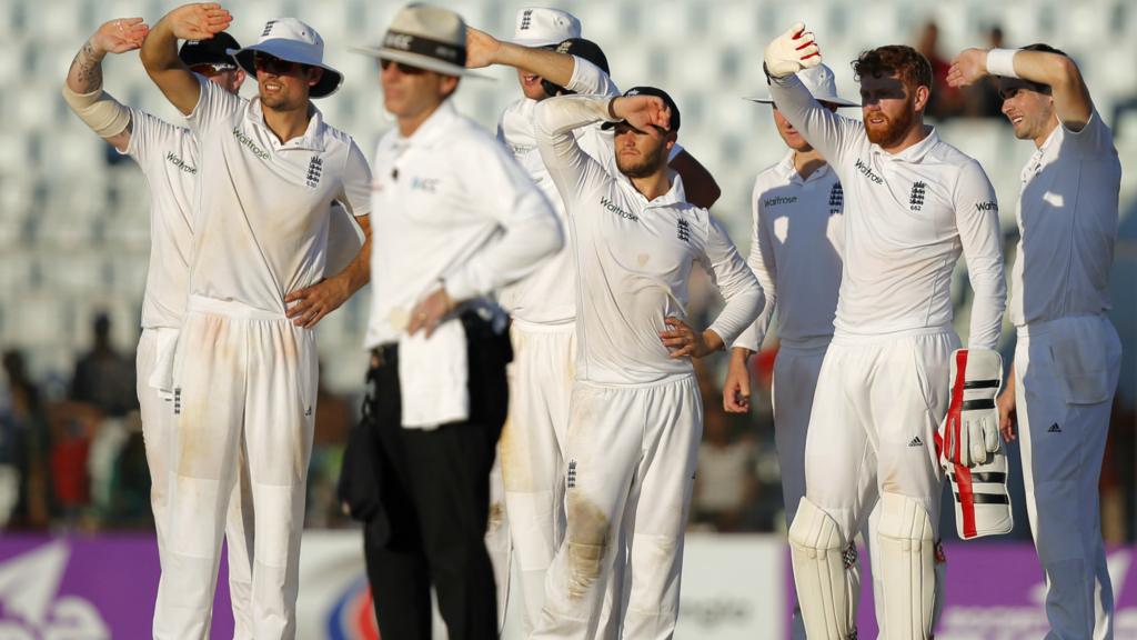 England's players wait for a review decision