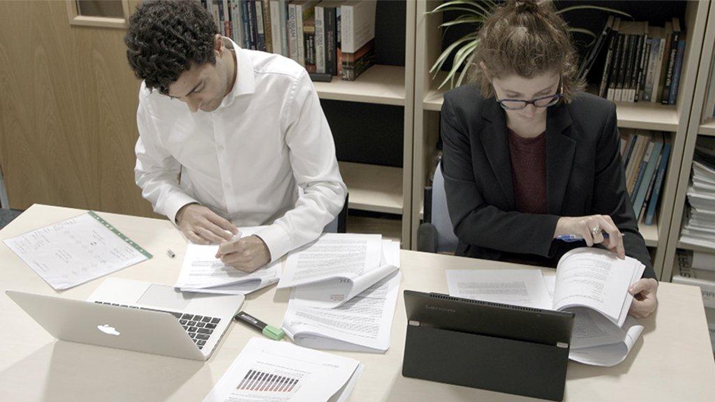 Vivek and Chrissy working at desk