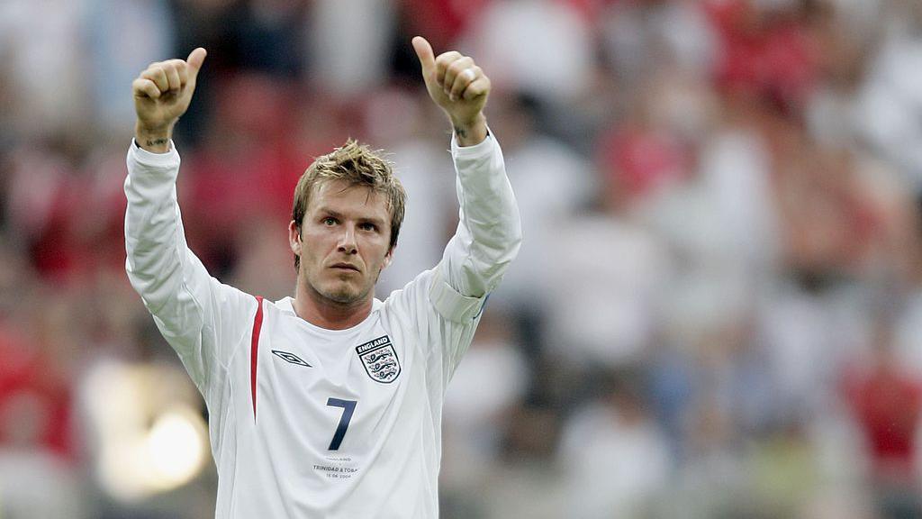 David Beckham in an England shirt, giving two thumbs up after a match.