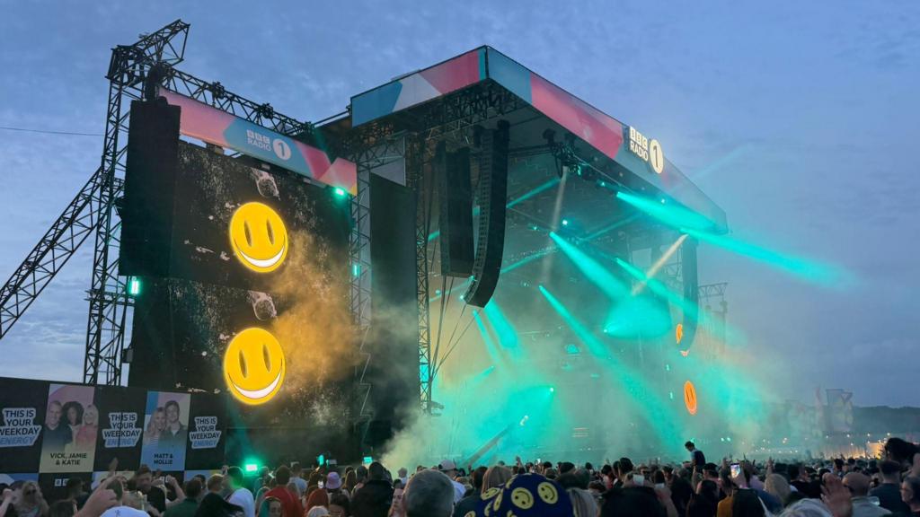 Lights fill the stage as Fatboy Slim plays his set