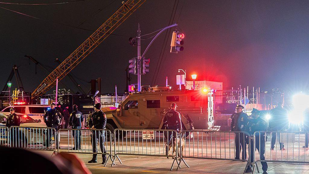 NYPD officers and an armoured vehicle.