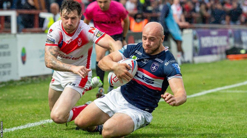 St Helens' Mark Percival can't stop Wakefield's Lee Kershaw from scoring a try