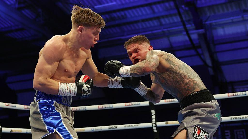 Giorgio Visioli lands a big punch as he fights Kane Baker