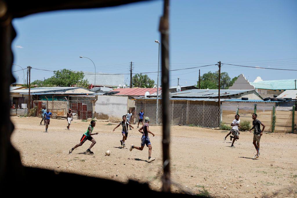 Men play football on a makeshift field in Windhoek 