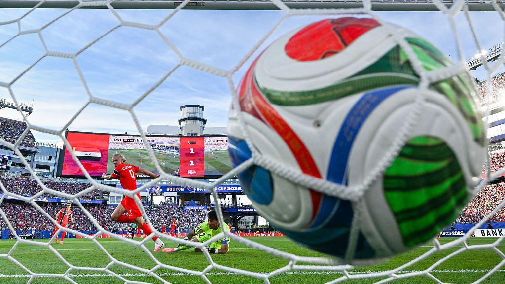 Haaland scoring a goal at the World Cup.