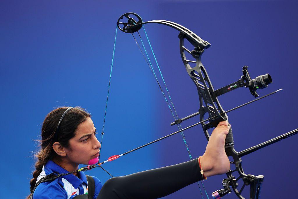 sheetal devi concentrates on her target using her foot to control a bow just moments before she sends an arrow