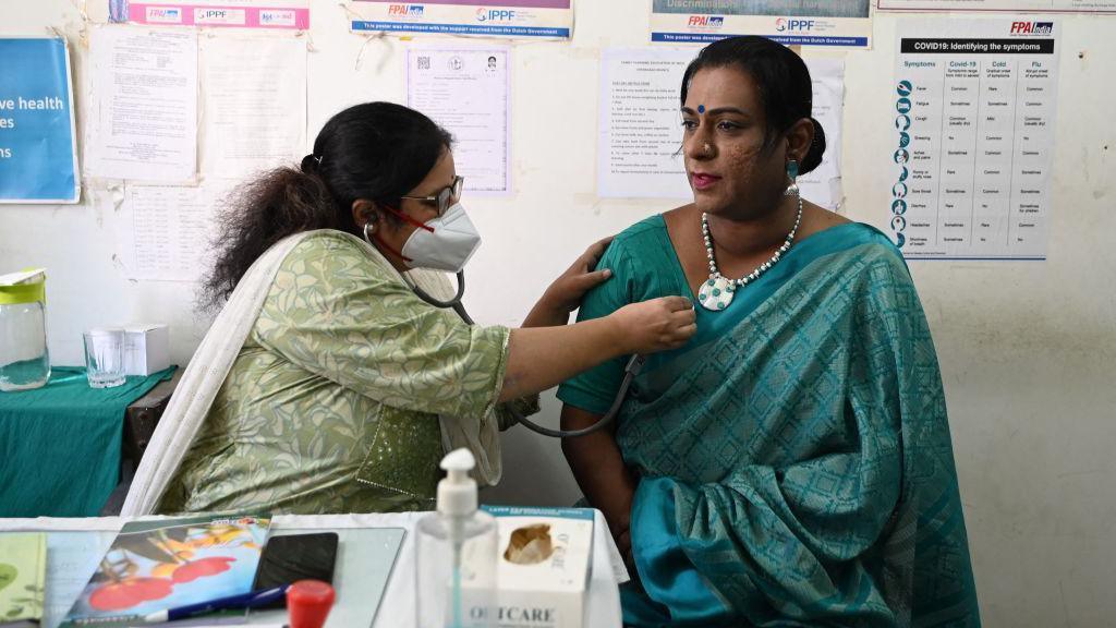 A doctor (L) examines a transgender woman at a free clinic for members of the transgender community in Hyderabad on January 28, 2023. (Photo by NOAH SEELAM / AFP) (Photo by NOAH SEELAM/AFP via Getty Images)