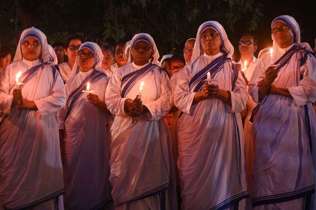 Indian Christian nuns are holding candles during a candlelight vigil outside a church to mark the one-year anniversary of the violent clashes that began on May 3, 2023, between the Meiteis and the Kuki-Zo ethnic groups in the northeastern state of Manipur, in New Delhi, India, on May 3, 2024. (