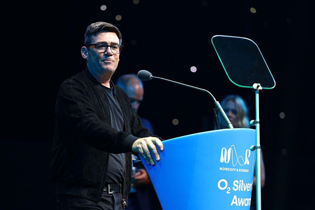 Andy Burnham speaks at a podium during the Silver Clef Awards
