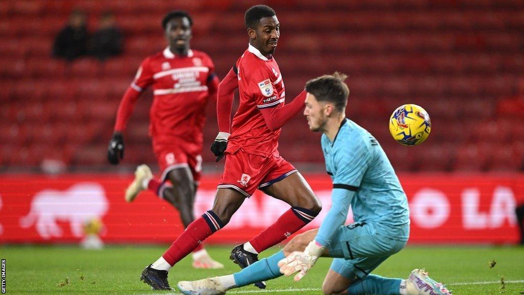 Middlesbrough's Isaiah Jones slides the ball past Preston goalkeeper Freddie Woodman to score his second goal