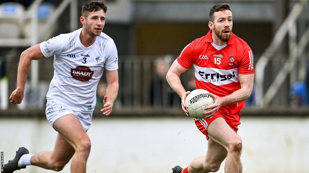 Derry forward Niall Loughlin outpaces Kildare's Shea Ryan in Newbridge