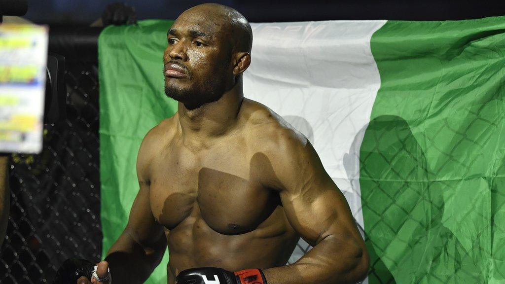 Kamaru Usman in front of Nigeria flag