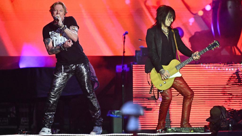 Axl Rose and Richard Fortus performing at Glastonbury