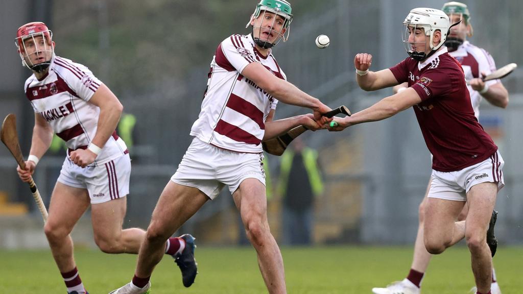 Cushendall's Ed McQuillan battles with Slaughtneil's Shane McGuigan at Pairc Esler