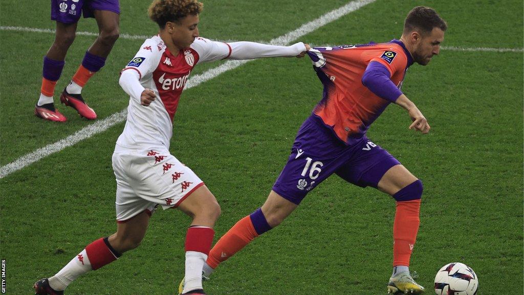 Monaco's French midfielder Eliesse Ben Seghir (L) fights for the ball with Nice's Welsh midfielder Aaron Ramsey (R) during the French L1 football match between AS Monaco and OGC Nice at the Louis II Stadium