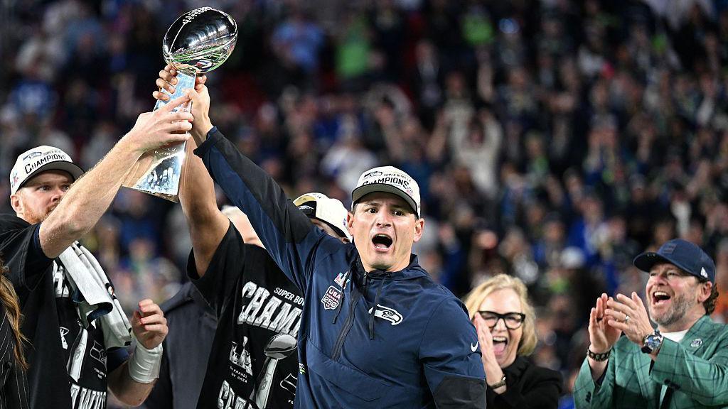 Mike Macdonald lifts the Lombardi trophy high
