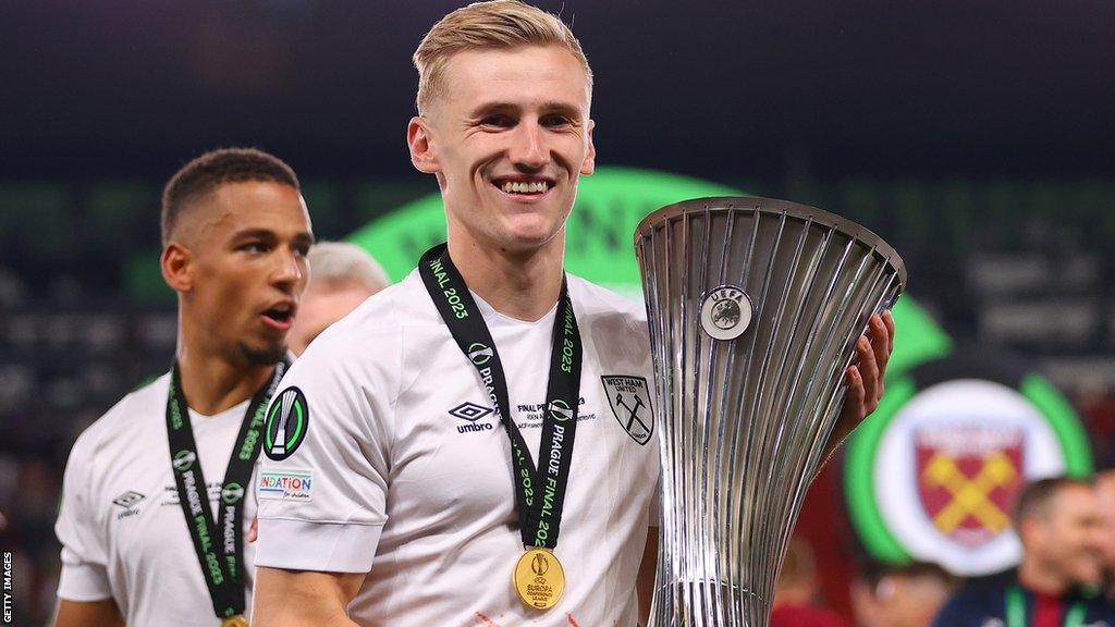 Flynn Downes wears a medal and holds the Uefa Europa Conference League trophy after West Ham beat Fiorentina in the final in Prague in June