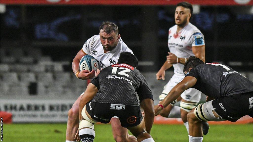 Ospreys' Sam Parry takes on the Sharks' defence