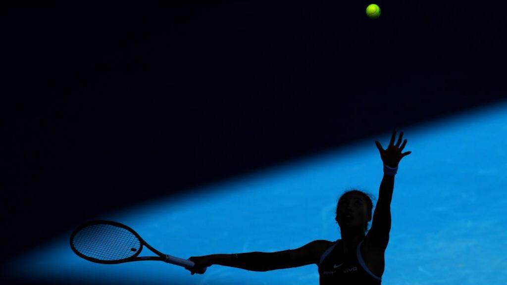 Qinwen Zheng of China serves during her charity match against Elina Svitolina of Ukraine ahead of the 2025 Australian Open at Melbourne Park in Melbourne, Australia