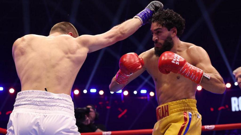 Simon Zachenhuber throws a punch at Hamzah Sheeraz