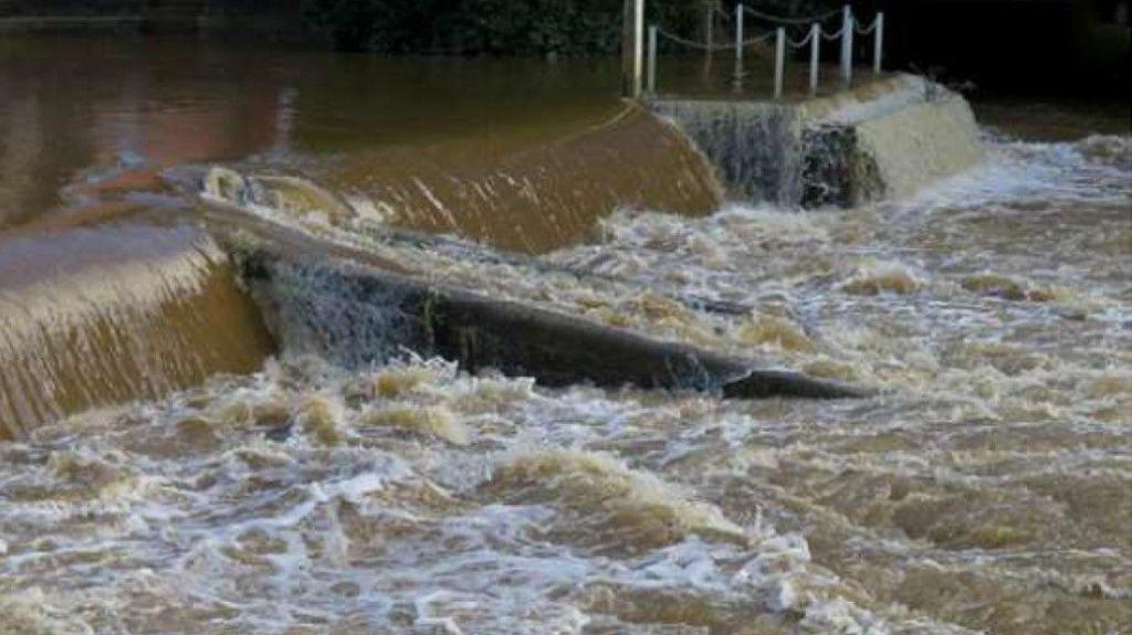 A shot of the river where the incident happened, showing fast-flowing brown water
