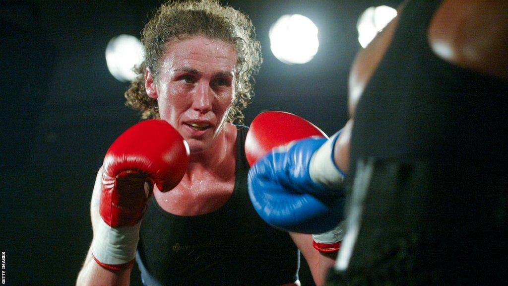 Jane Couch in the ring with her boxing gloves up