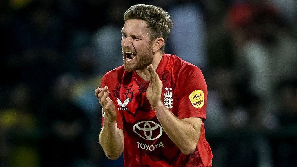 Liam Dawson celebrates while playing for England